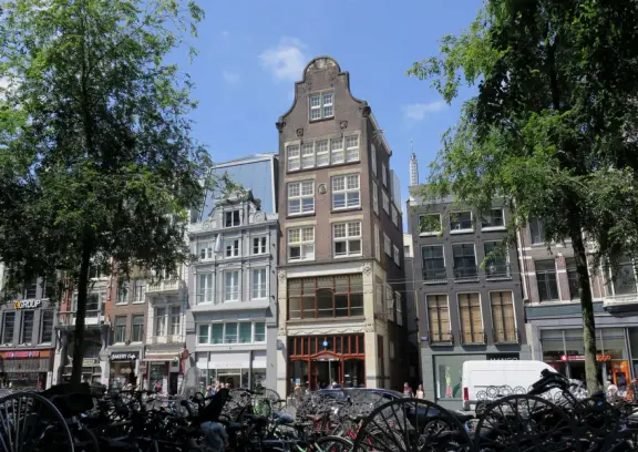 Flowers on bridges over canals, leafy outdoor seating at cafes, bustling streets, interesting museums, gingerbread architecture.