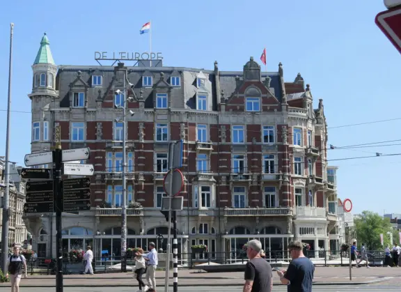 Flowers on bridges over canals, leafy outdoor seating at cafes, bustling streets, interesting museums, gingerbread architecture.