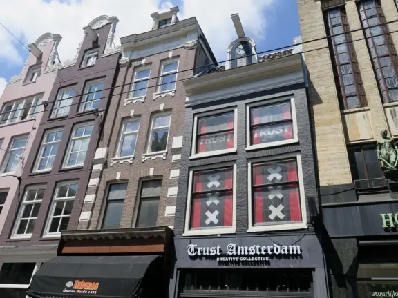 Flowers on bridges over canals, leafy outdoor seating at cafes, bustling streets, interesting museums, gingerbread architecture.