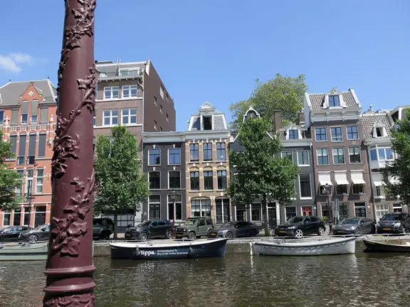 Flowers on bridges over canals, leafy outdoor seating at cafes, bustling streets, interesting museums, gingerbread architecture.