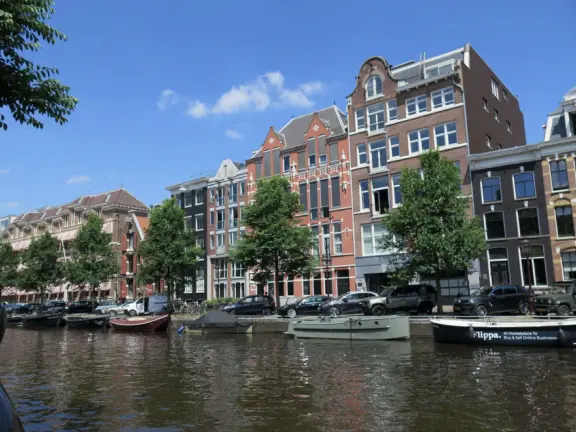 Flowers on bridges over canals, leafy outdoor seating at cafes, bustling streets, interesting museums, gingerbread architecture.