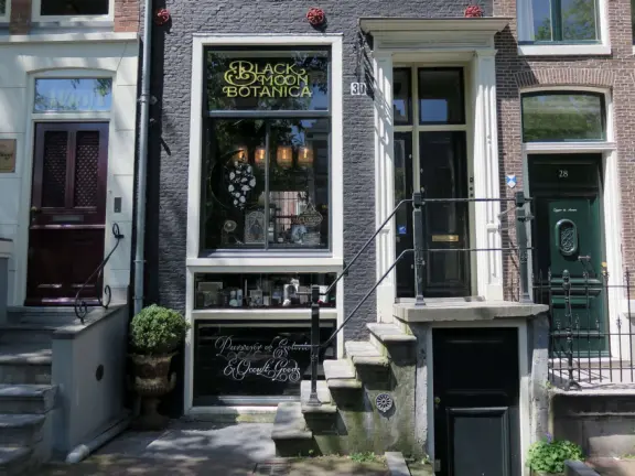 Flowers on bridges over canals, leafy outdoor seating at cafes, bustling streets, interesting museums, gingerbread architecture.