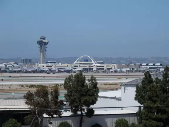 Sidewalk with chess tables, benches, and telescopes, where you can watch the airplanes land and take-off from LAX.