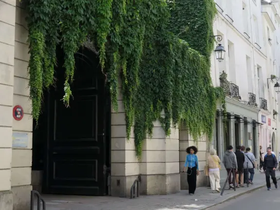 An ancient, pretty street with upscale shops in attractive storefronts. It leads south to the Seine River.