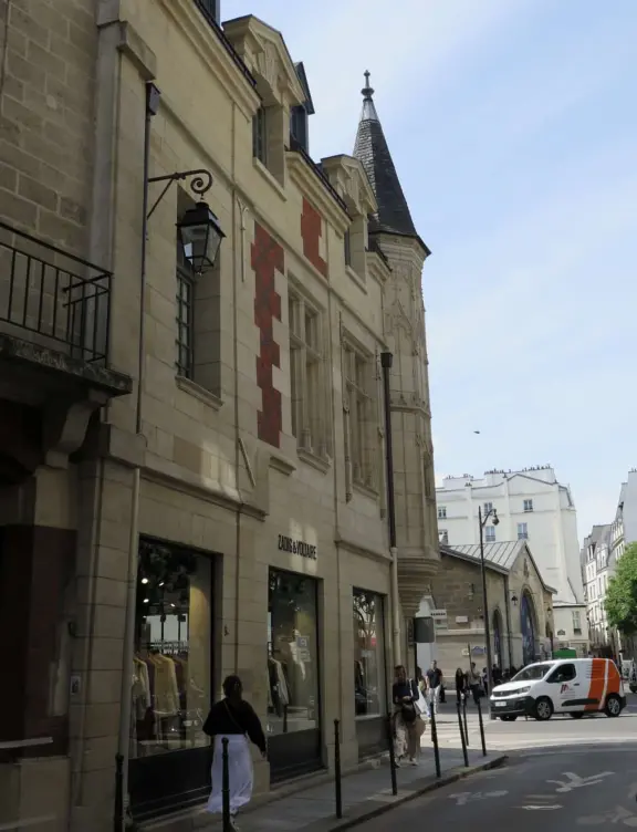 An ancient, pretty street with upscale shops in attractive storefronts. It leads south to the Seine River.