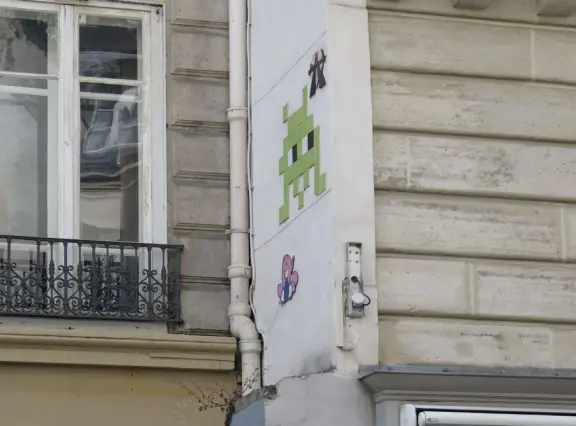 An ancient, pretty street with upscale shops in attractive storefronts. It leads south to the Seine River.