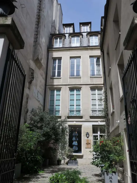 An ancient, pretty street with upscale shops in attractive storefronts. It leads south to the Seine River.