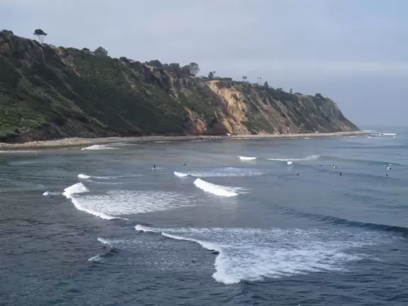 Emerald green cove with stunning high yellow cliffs.