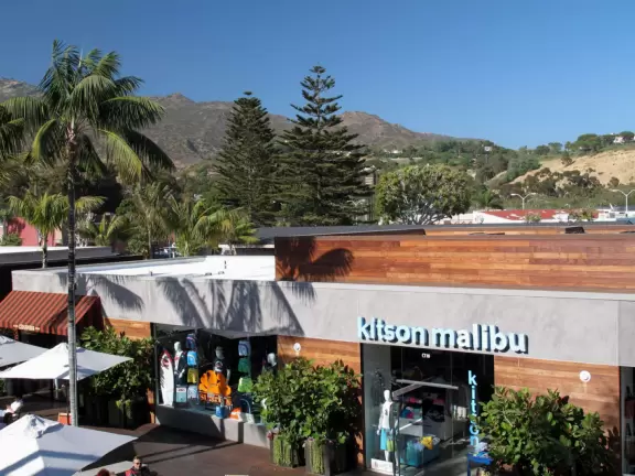 Fantastic outdoor mall with palm trees swishing in the breeze over a hardwood deck and a wood stage with live music on weekends.