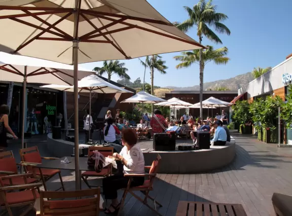 Fantastic outdoor mall with palm trees swishing in the breeze over a hardwood deck and a wood stage with live music on weekends.