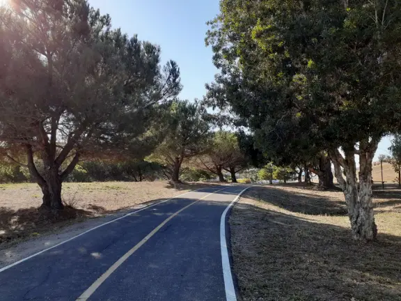 Bike path with views of hills all around, and pretty neighborhood nearby.