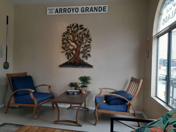 Nice little main street, with cafes, pretty storefronts, park, swinging bridge over a creek with tropical vegetation, and neighborhood with white picket fences and gardens.