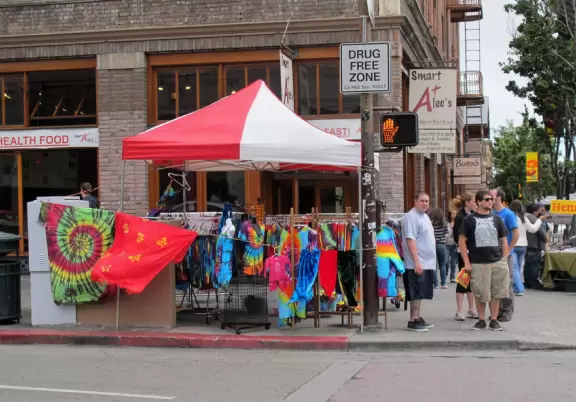 Wild street of sights and smells, ironically labeled a "Drug Free Zone."