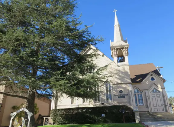 Nice little main street, with cafes, pretty storefronts, park, swinging bridge over a creek with tropical vegetation, and neighborhood with white picket fences and gardens.