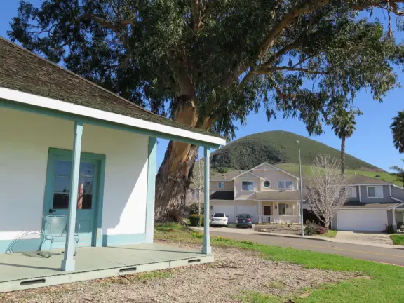 A peaceful 3-mile walk through oaky forest, past lush landscaping and a park with a historic adobe house, and among a neighborhood with gardens filled with flowers.