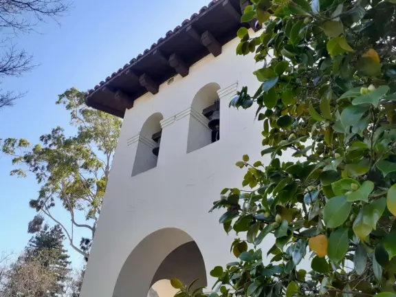 Spanish mission from late 18th century, in downtown San Luis Obispo, with giant roses in the garden behind and a lively plaza in front.