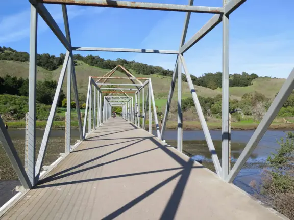 Wide partially shady path that leads through oak forest, past a market, and a Secret Garden with live music, to Avila Beach.