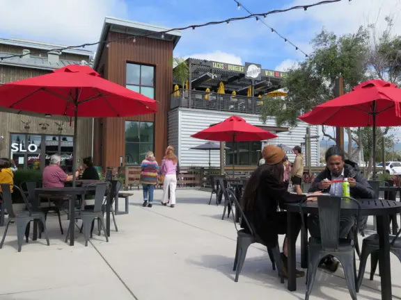 Attractive public market with sunny outdoor space and cute balcony upstairs.