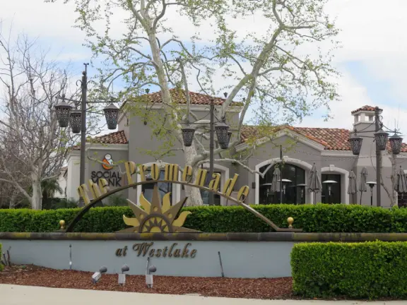 Entrance to the shopping center, with lanterns, Spanish tile, and pretty trees. 