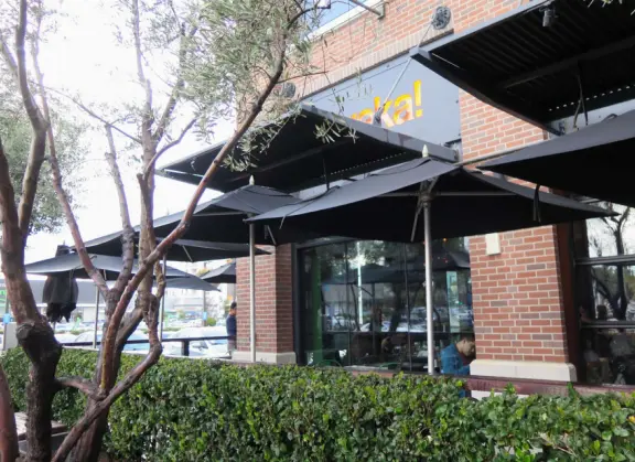 Modern outdoor mall with many places to eat, and nice decor.