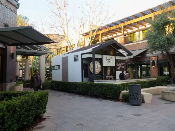 Modern outdoor mall with many places to eat, and nice decor.