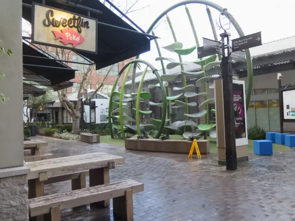 Modern outdoor mall with many places to eat, and nice decor.