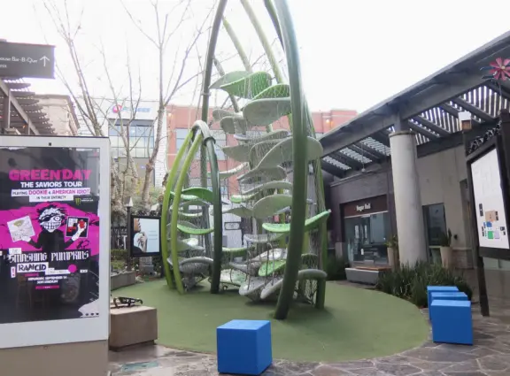 Modern outdoor mall with many places to eat, and nice decor.