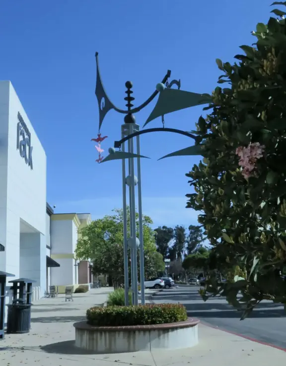 An outdoor shopping plaza with many fun stores.