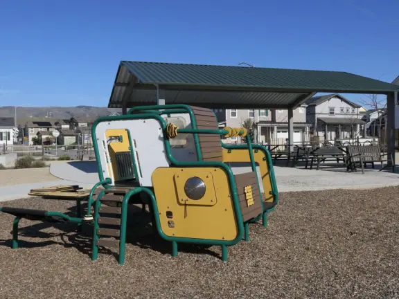 A colorful, fun playground with huge twisty slide, three-level climby, tractor, baby swings, basketball court, and giant lawn. Also called San Luis Ranch.&nbsp;