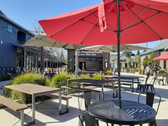 Attractive public market with sunny outdoor space and cute balcony upstairs.