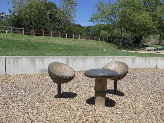 Incredible playground in a warm valley, with a pretty trail to walk.