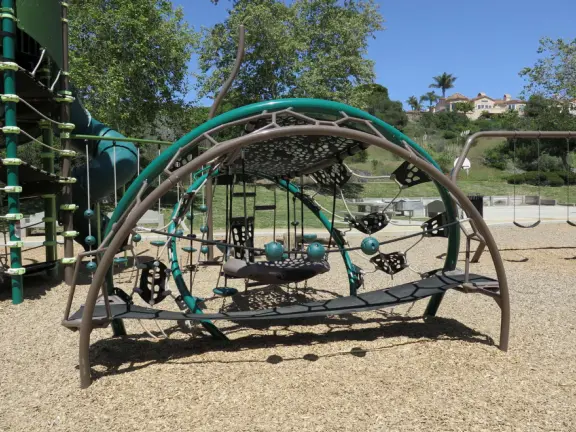 Incredible playground in a warm valley, with a pretty trail to walk.