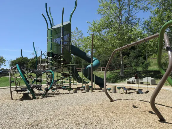 Incredible playground in a warm valley, with a pretty trail to walk.