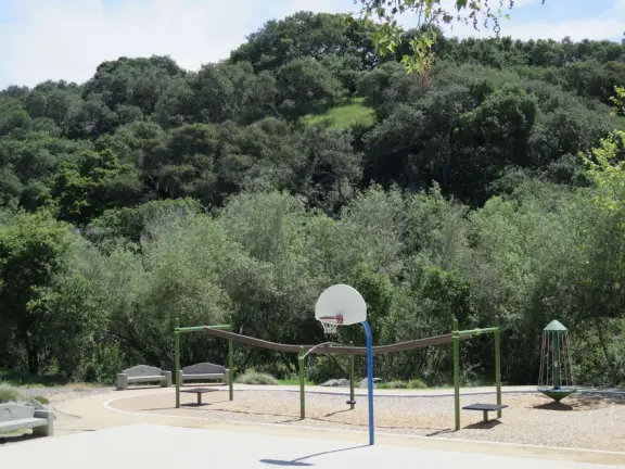 Incredible playground in a warm valley, with a pretty trail to walk.