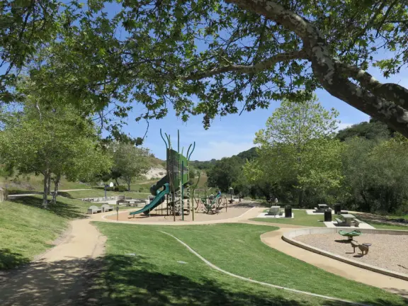 Incredible playground in a warm valley, with a pretty trail to walk.
