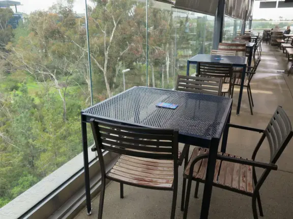 Shopping plaza with a deck offering lots of attractive public space, a trampoline for young kids, a sky deck bar, a dark public market with lights, cafes, stores and coffee shops.