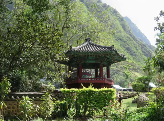 A gorgeous public garden under high mountain ridges, with dwellings representing the many cultures that are found in Maui: Portuguese, Chinese, Japanese, Filipino, Hawaiian, and New England.