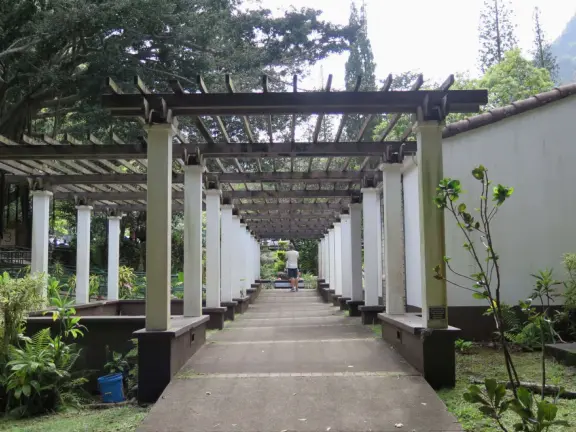 A gorgeous public garden under high mountain ridges, with dwellings representing the many cultures that are found in Maui: Portuguese, Chinese, Japanese, Filipino, Hawaiian, and New England.
