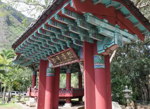 A gorgeous public garden under high mountain ridges, with dwellings representing the many cultures that are found in Maui: Portuguese, Chinese, Japanese, Filipino, Hawaiian, and New England.