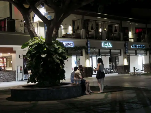 A small, attractive shopping center with cafes, boutiques, a coffee shop, a farmers market, and nice lights at night.