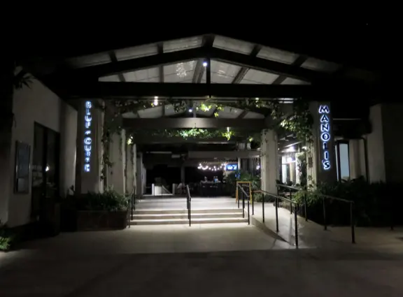 A small, attractive shopping center with cafes, boutiques, a coffee shop, a farmers market, and nice lights at night.