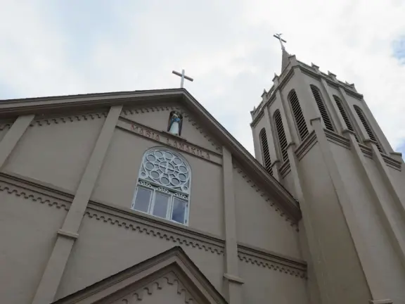 A church that miraculously survived the Lahaina fire. It's garden with mango trees and statues also survived, while beside it is rubble everywhere.