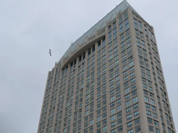 A Spanish-style plaza with cafes and shops, in a historic police headquarters complex.