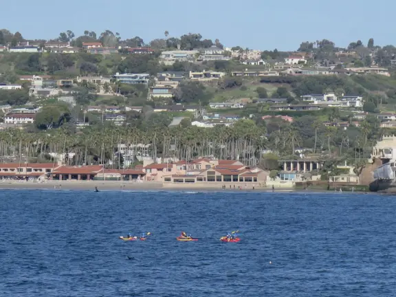 Beach with boardwalk, playground, magical mansion, and kayak rentals to kayak to sea caves, plus cafes nearby.