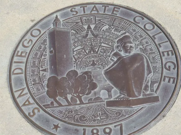 Modern campus with tropical blooming trees and Spanish architecture on the northern end of campus.