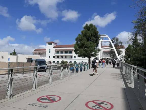 Modern campus with tropical blooming trees and Spanish architecture on the northern end of campus.