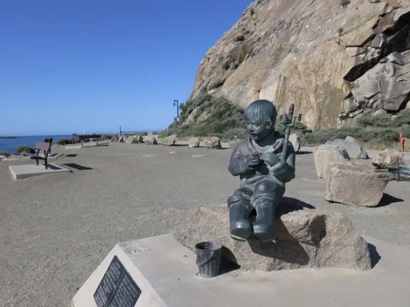 Fisherman's Family sculpture on the sunny sheltered side of Morro Rock. 
