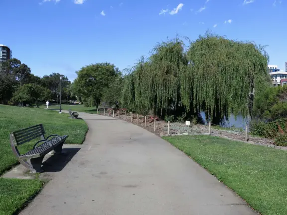 Modern area, also called Mission Bay, with French bakery, waterfront bike path that connects to Embarcadero, and views across to Oracle Park stadium and the Bay Bridge.