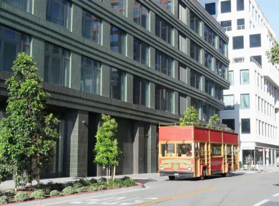 Modern area, also called Mission Bay, with French bakery, waterfront bike path that connects to Embarcadero, and views across to Oracle Park stadium and the Bay Bridge.