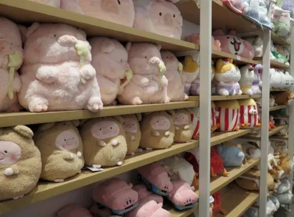 A modern, elegant mall with a Miniso Asian goods store, Hollister Co. teen clothing, Claire's Accessories, Hobby Lobby crafts, The Children's Place kids clothing, and large department stores.